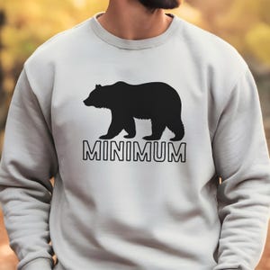 May include: A gray sweatshirt with a black bear silhouette and the word "MINIMUM" printed on the front.