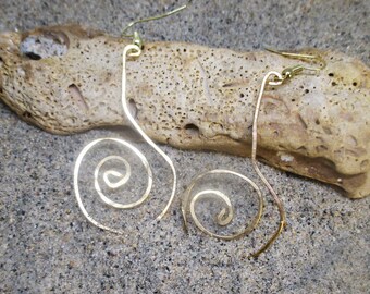 May include: A pair of gold-toned earrings with a spiral design. The earrings are made of thin wire and have a simple, elegant look.