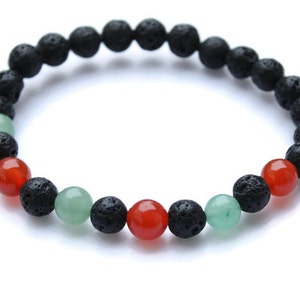 May include: A black lava rock bracelet with red and green gemstone beads.
