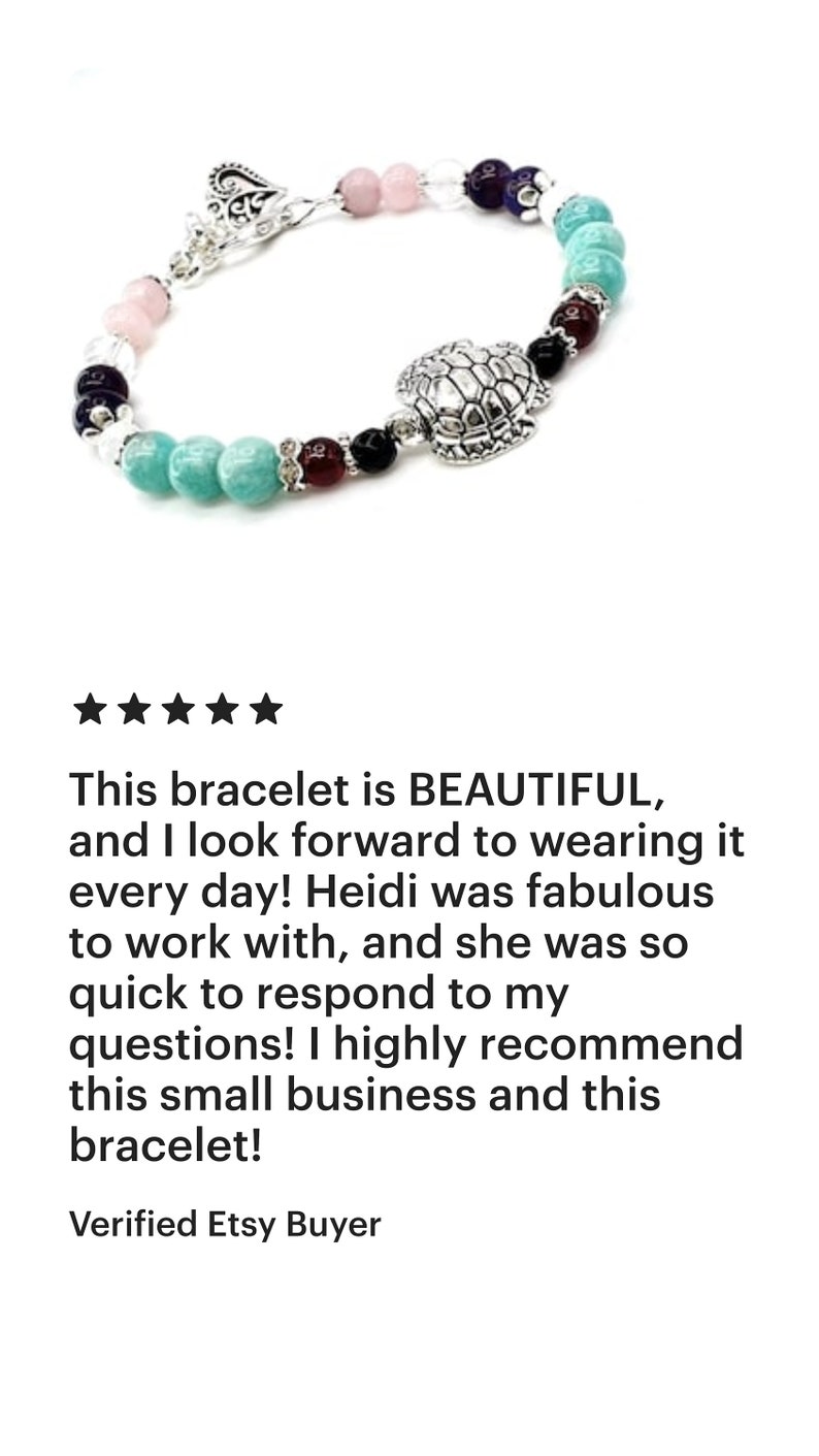 May include: A beaded bracelet featuring a silver turtle charm and a variety of colorful beads, including turquoise, pink, purple, and clear beads. The bracelet has a silver clasp. The text on the image says: "This bracelet is BEAUTIFUL..."