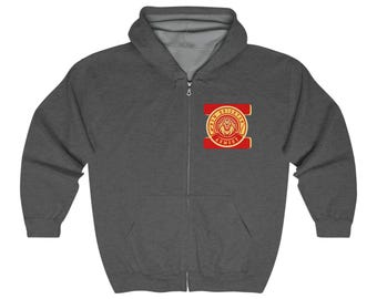 May include: A charcoal gray zip-up hoodie with a drawstring hood. The hoodie features a red and gold emblem on the chest with the text "KEY BRISTOL ARMORY" surrounding a lion's head.