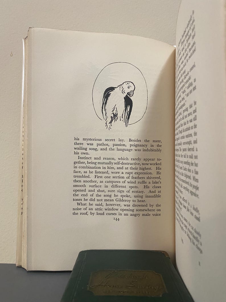 May include: Open book with text and a black and white illustration of a parrot inside a circle. The text describes a mysterious secret and the parrot's rapt expression.