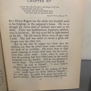 May include: Open book with text from "Chapter XIV" of a book. The text is in black font on aged, off-white paper. The text includes poetry and prose. The page number "177" is visible at the bottom of the page.
