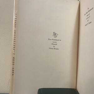 May include: Open book pages with text and a small illustration. The text reads "First Published in 1929 Printed in Great Britain." The book is open to a page with text on the left and right sides.