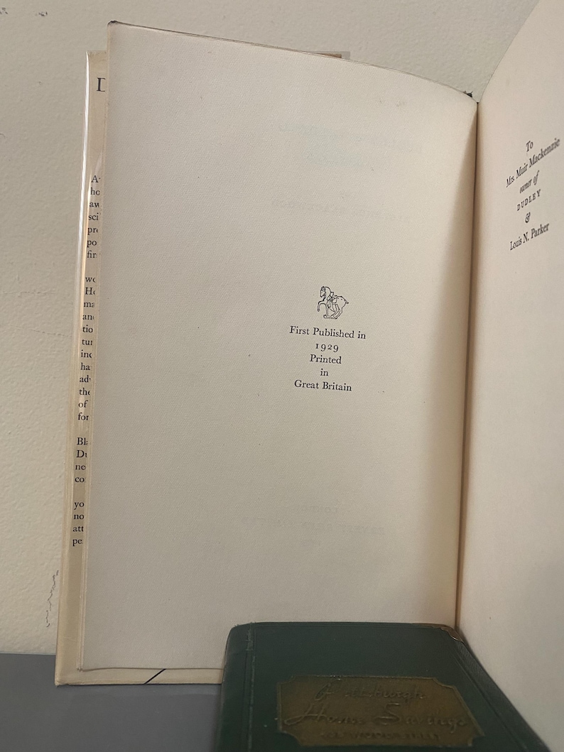 May include: Open book pages with text and a small illustration. The text reads "First Published in 1929 Printed in Great Britain." The book is open to a page with text on the left and right sides.