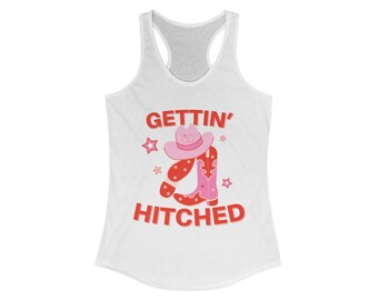 Puede incluir: Camiseta blanca de tirantes con el texto "GETTIN' HITCHED" en rojo y un gráfico de un sombrero de vaquero rosa y botas.