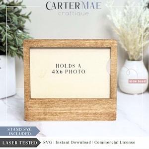 May include: A wooden picture frame with a light brown stain. The frame is designed to hold a 4x6 inch photo and has a side-loading design. The text "HOLDS A 4X6 PHOTO" is printed on the frame.