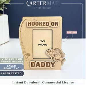 May include: Wooden photo frame with a fishing rod and fish design. The frame says "Hooked on Daddy" and has a 2x3 photo opening. It is laser cut and ready to be assembled.
