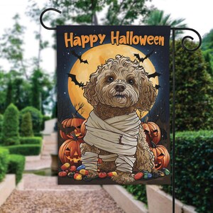 May include: A Halloween-themed garden flag featuring a brown and white dog dressed as a mummy. The dog is surrounded by pumpkins and candy. The flag reads "Happy Halloween".