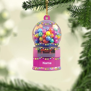 May include: Pink gumball machine Christmas ornament with colorful gumballs and lights. The ornament has the word "Name" on the front.