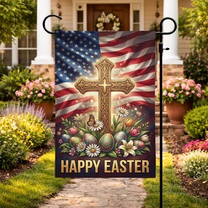 May include: A garden flag featuring an American flag design with a gold cross, Easter eggs, flowers, and the text "HAPPY EASTER." The flag is displayed outdoors on a black metal stand, with a house and garden in the background.
