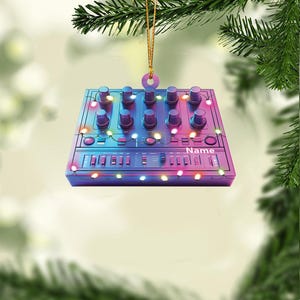 May include: A purple and blue synthesizer Christmas ornament with colorful lights. The ornament has a name tag that says "Name".