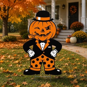 May include: A decorative yard sign featuring a winking pumpkin character wearing a black bowler hat with an orange band, a black tuxedo jacket with a white shirt and bow tie, and orange pants with black polka dots, holding a brown pipe.