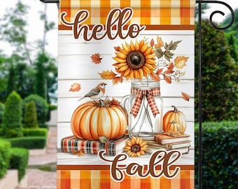 May include: A fall-themed garden flag with a white wood background. The flag features a mason jar filled with sunflowers and fall leaves, a pumpkin, a bird, and books. The text "hello fall" is written in brown lettering.