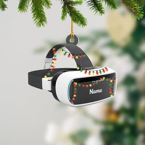 May include: A white virtual reality headset with a black strap decorated with colorful Christmas lights. The headset has a black lens and the text "Name" is printed on the front.