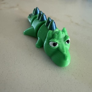 Green Grass Macky, the articulated sensory fidget toy for kids. Its not a tiny dragon, its a Macky.