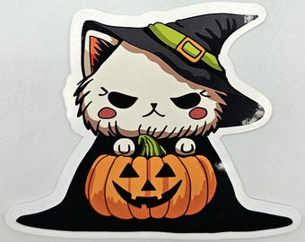 May include: A die-cut sticker featuring a white cat with a grumpy expression wearing a black witch hat with a green band and buckle. The cat is wrapped in a black cloak and is holding an orange jack-o'-lantern pumpkin with a carved face.