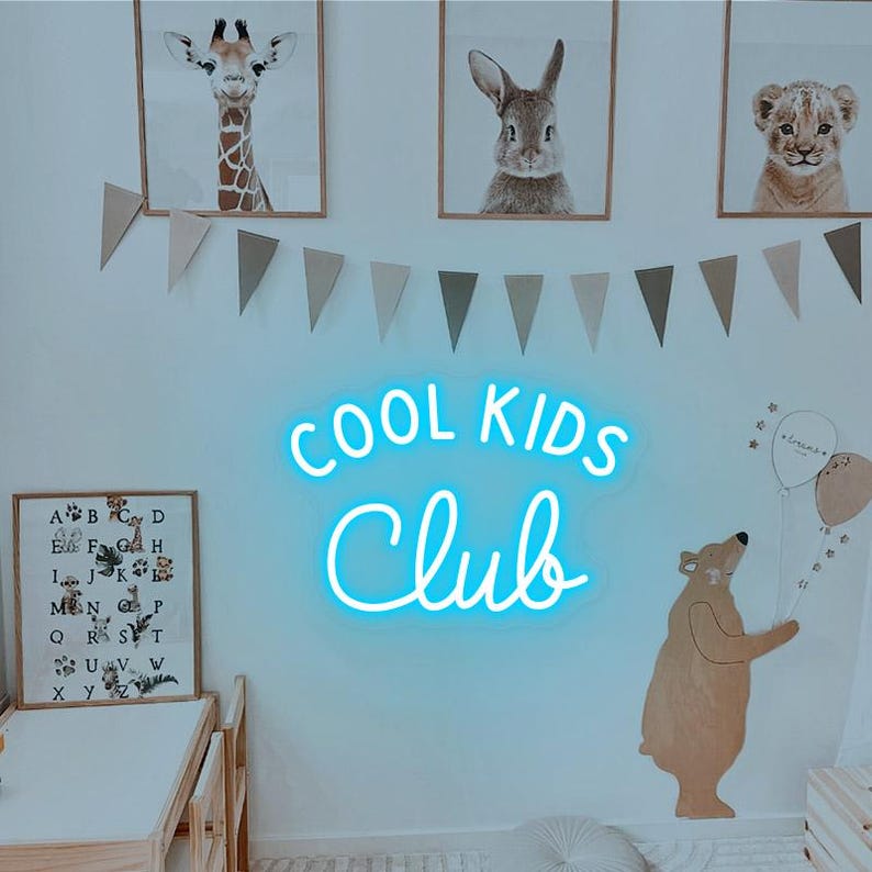 May include: A blue neon sign with the text "COOL KIDS CLUB" in a white room with a wooden bear, a giraffe, a rabbit, and a lion picture on the wall.