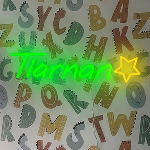 May include: A neon green sign displaying the name "Tiannan" in a cursive font, with a yellow star to the right. The sign is against a patterned background of colorful letters and dinosaur shapes.