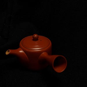 May include: A set of three ceramic mugs with a speckled, matte finish. The mugs are in shades of cream, light gray, and dark gray. Each mug has a simple, minimalist design, perfect for coffee or tea.