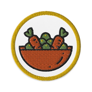 Könnte beinhalten: Ein gestickter Aufnäher mit einer Schüssel voller Karotten und grünem Gemüse in Gelb und Orange.