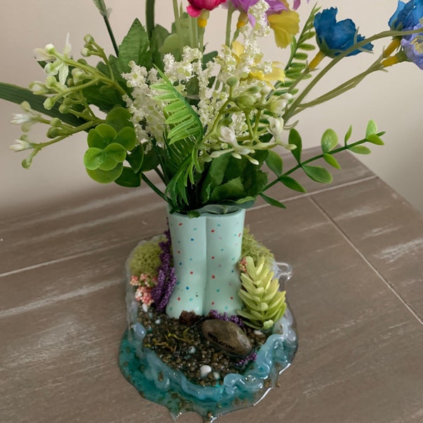 Original and one of a kind. Small flower arrangements in tiny polka dotted boots with resin base