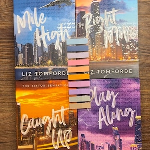 May include: Four paperback books with cityscapes on the covers. The titles are "Mile High", "The Right Move", "Caught Up", and "Play Along". All four books are by Liz Tomforde, the TikTok sensation.