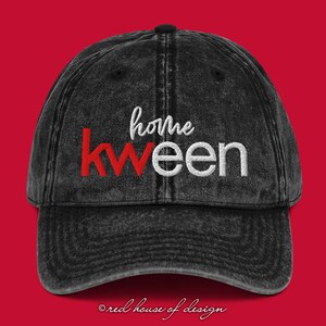May include: Black vintage style baseball cap with white embroidered text that reads "home kweem" with the "kweem" in red.