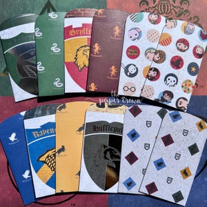 May include: A collection of twelve rectangular paper envelopes featuring various Harry Potter themed designs, including house crests for Gryffindor, Slytherin, Ravenclaw, and Hufflepuff, alongside character icons, patterns, and the text the paper crown.