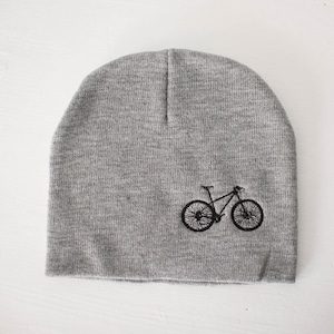 May include: Grey beanie with a black embroidered mountain bike design.