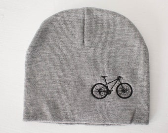 May include: Gray beanie with a black embroidered mountain bike design.