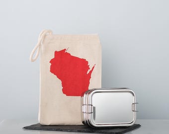 May include: A stainless steel lunch box with a red outline of the state of Wisconsin on a white canvas bag.