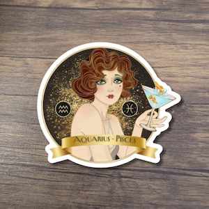 May include: A sticker featuring a vintage illustration of a woman with red hair, holding a cocktail with goldfish. The sticker has a gold and black background with the text "Aquarius - Pisces" on a gold banner. Zodiac symbols are also included.