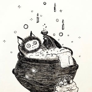 May include: A black and white illustration of a bat taking a bubble bath in a cauldron. The bat is wearing a towel and there are candles and bubbles around it.