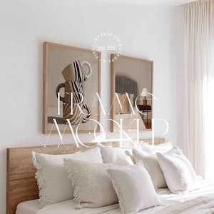 May include: Two framed art prints with a light wood frame are displayed above a bed with white bedding and pillows. One print features stacked coffee cups with brown and cream stripes. The other print shows a bed with a striped headboard and a lamp.