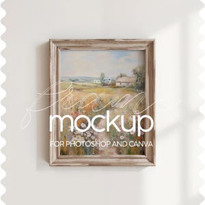 May include: A rustic wooden frame with a light brown finish, displaying a painting of a countryside scene with a small house and a path leading through a field of flowers. The text "no. 419" is visible in the painting. The frame is suitable for use as a mockup for Photoshop and Canva.