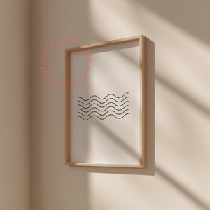 May include: A framed print with a simple black and white wave design. The frame is light wood and the print is on white paper.