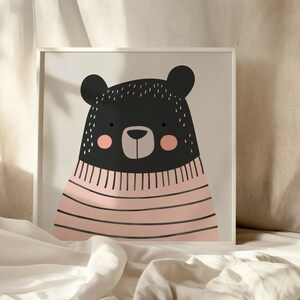 May include: A black bear wearing a pink and white striped sweater. The bear has a cute, cartoon-like face with black eyes, a brown nose, and pink cheeks.