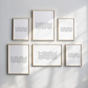 May include: Set of six minimalist black and white wave prints in wooden frames. The prints are arranged in a grid pattern on a white wall.