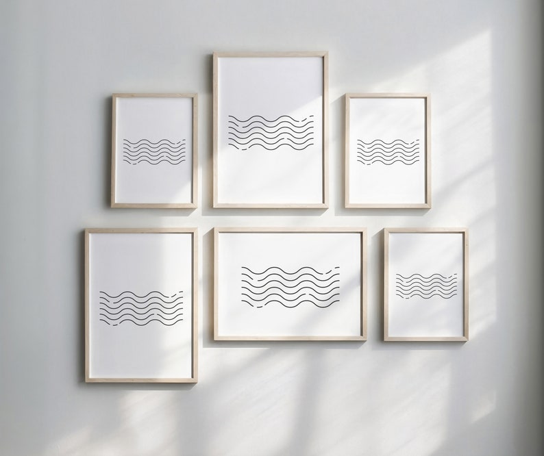 May include: Set of six minimalist black and white wave prints in wooden frames. The prints are arranged in a grid pattern on a white wall.