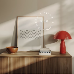Puede incluir: Un cuadro minimalista enmarcado con un diseño de líneas onduladas negras. Una lámpara roja con forma de hongo y un cuenco de madera están sobre un mueble de madera. El texto "No. 197" y "Ratio 4:5" son visibles.
