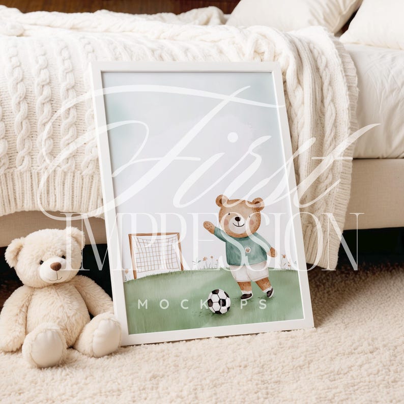 May include: A watercolor illustration of a brown bear wearing a green and white soccer uniform, kicking a soccer ball. The bear is standing on a green field with a white goal in the background. The illustration is framed in a white frame and is sitting on a white fluffy rug.