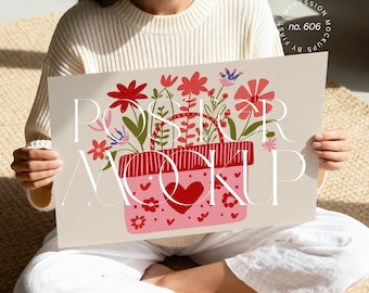 May include: A poster mockup featuring a floral design with a red and pink color scheme. The design includes a basket filled with flowers and the text "POSTER MOCKUP". The poster is held by a person.