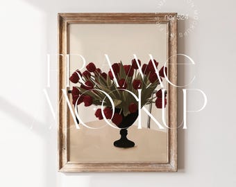 May include: A framed art print featuring a still life of red tulips in a black vase. The artwork is set against a neutral background and framed in a light-colored wooden frame. The text "FRAME MOCKUP" is overlaid on the image.