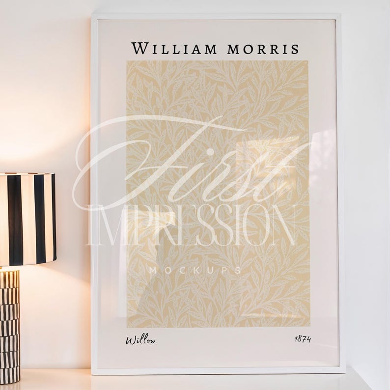 May include: A framed art print featuring a William Morris design. The print has a cream-colored background with a repeating pattern of stylized leaves and branches. The text "WILLIAM MORRIS" is at the top, with "Willow" and "1874" at the bottom.