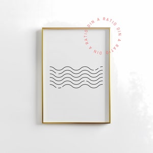 May include: A framed print with a minimalist design of black wavy lines on a white background. The frame is gold and the print is titled "Din A Ratio Din A Ratio".