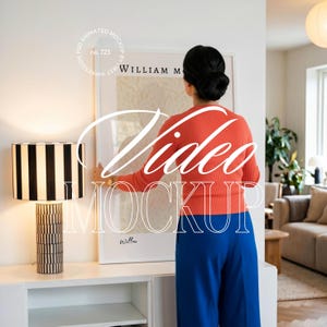 May include: A modern living room scene featuring a framed art print with the text "William M" and a decorative lamp with a black and white striped shade. The image also includes the text "Video Mockup".