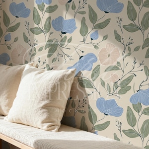 May include: A cream-colored bench with two off-white pillows in front of a floral wallpaper. The wallpaper features blue and pink flowers with green leaves and stems against a cream background.