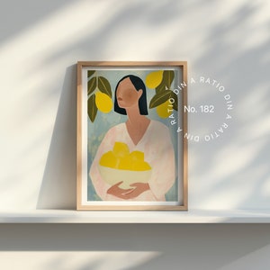 May include: A framed illustration of a woman with dark hair holding a bowl of lemons. The background is a light blue with green leaves and yellow lemons. The frame is light wood. The text "RATIO DIN A RATIO DIN A No. 182" is printed in a circle around the frame.