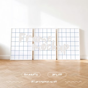 May include: Three white picture frames with a grid pattern on the inside of the frame. The frames are on a light wood floor. The text "Frame Mockup" is written in white on the frames.